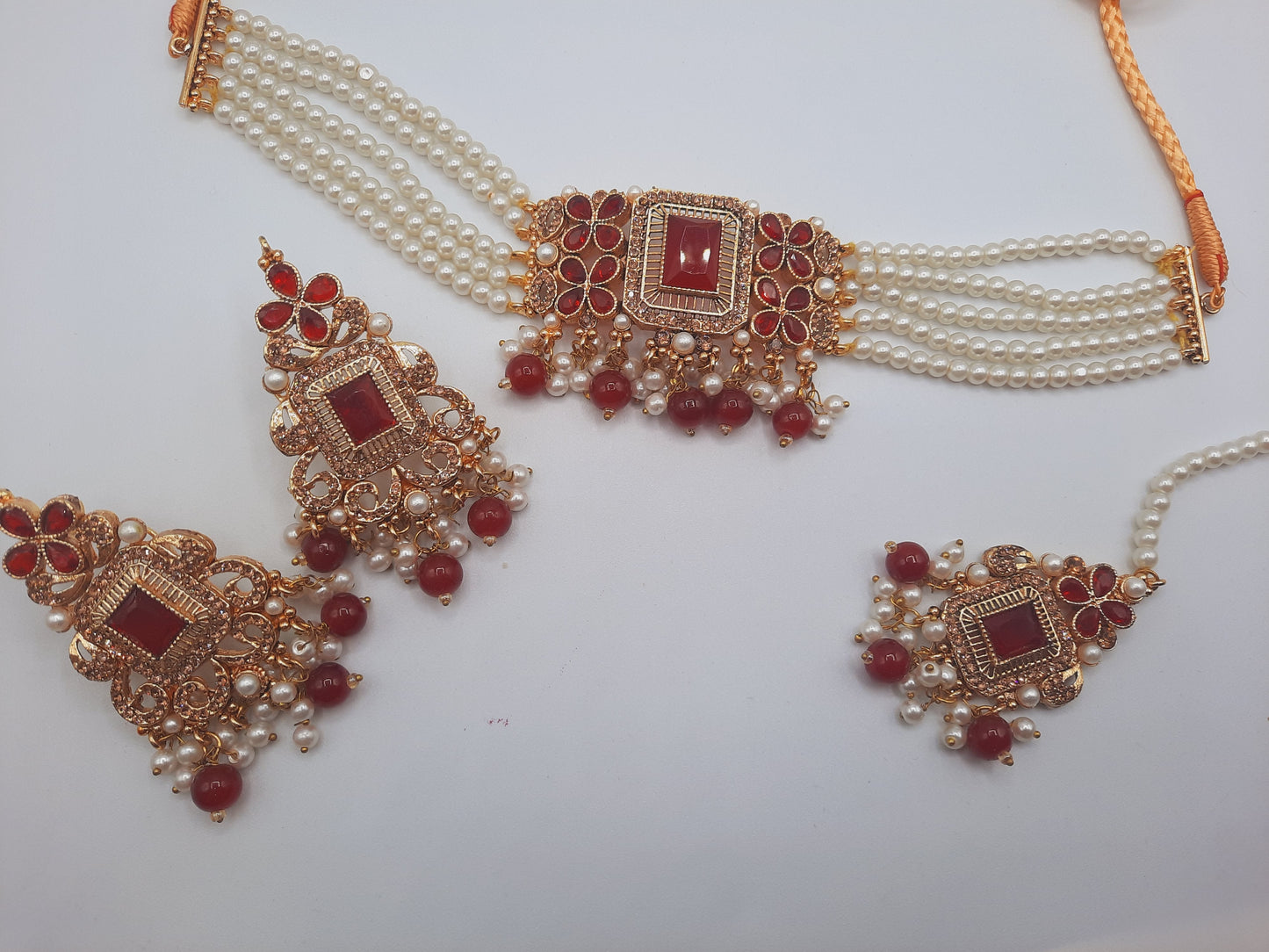 Anarkali choker set with guluband earrings and teeka in red color with gold plated tone - NATASHAHS