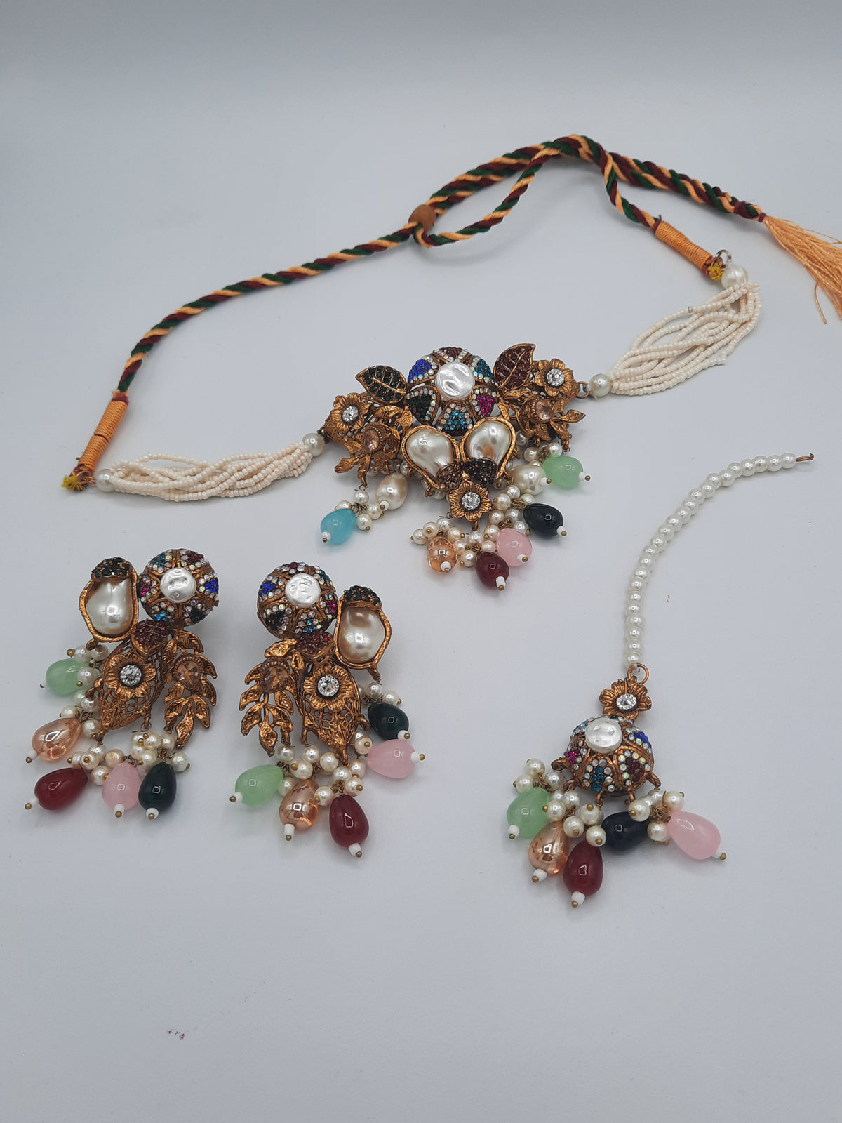 Turkish-style multi-color stone and pearl choker set with matching earrings and a maang tikka.